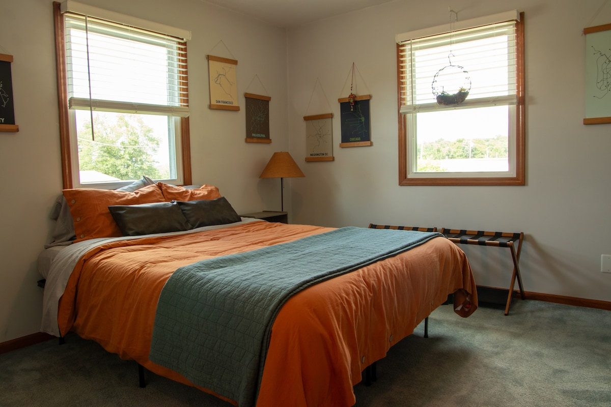 The second queen bedroom, with city map prints on the wall