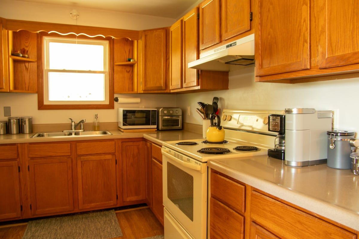 The kitchen, with full-size range, microwave, coffee maker and kettle