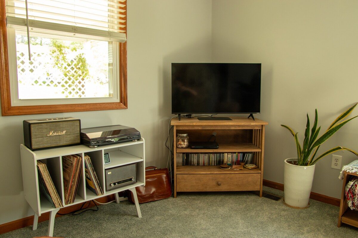 The record player and vinyl crate beside the living room window