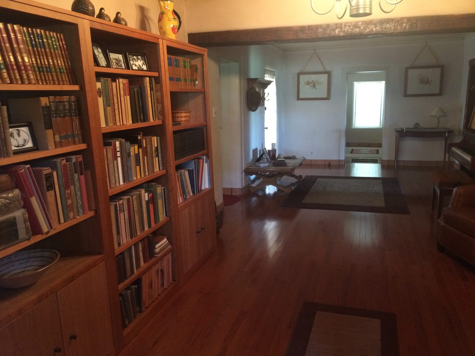 Bookshelves along the hall, looking through to the far room