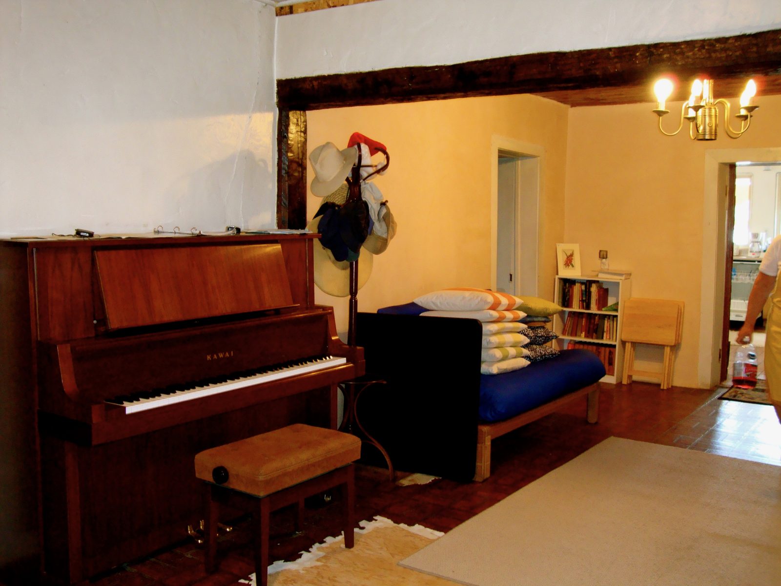The piano, under the hat rack and the old ceiling beam
